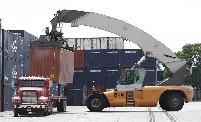 container being loaded on chassis